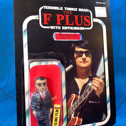 a toy of Roy Orbison wrapped in Clingfilm by Jimmyfranks