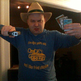 an Aaron tank shirt, a gun, and magic cards