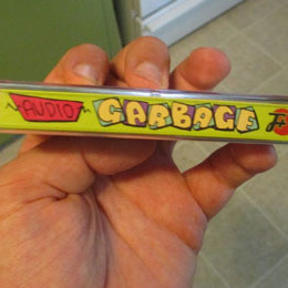 Audio Garbage casette, held to show spine