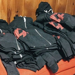 a pile of F+ hoodies