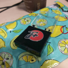 pin in case, sitting on a lemon envelope