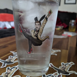 a clear sexy bunnybread sticker on a pint glass