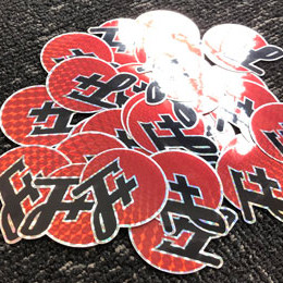a pile of prismatic stickers, caught in a sunbeam
