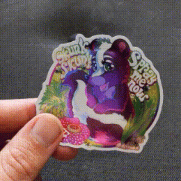 a Skunk Skunk Spray me now sticker glimmering in the light